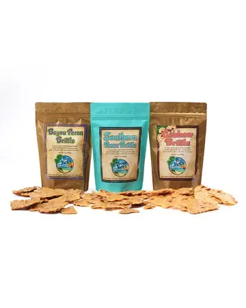 Three bags of crackers are sitting next to each other on a table.