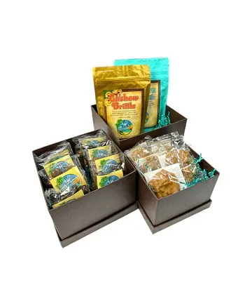 Three boxes filled with different types of cookies and snacks.