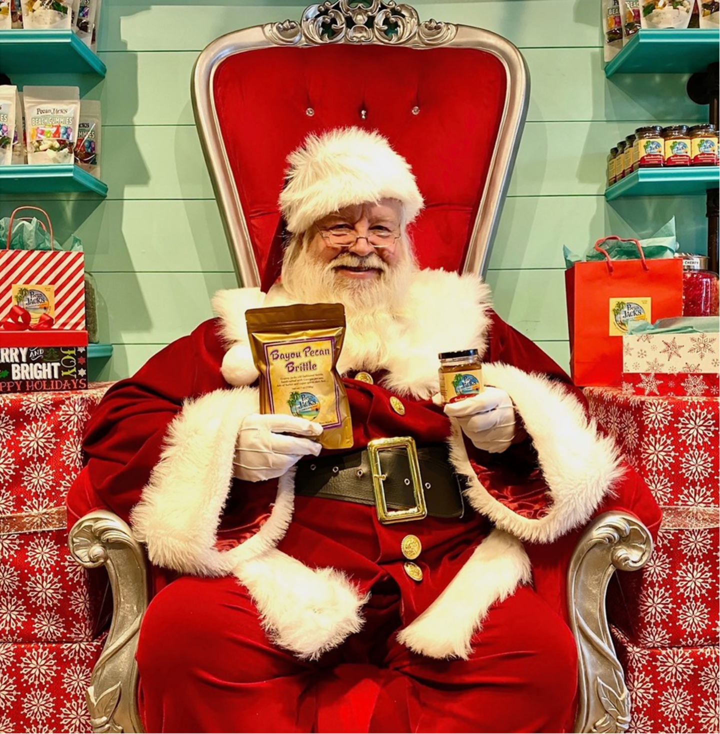 Santa claus is sitting in a chair holding a bag of sugar free butter