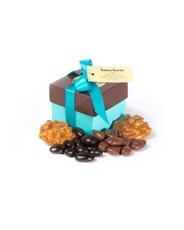 A blue box with a blue ribbon and nuts in it