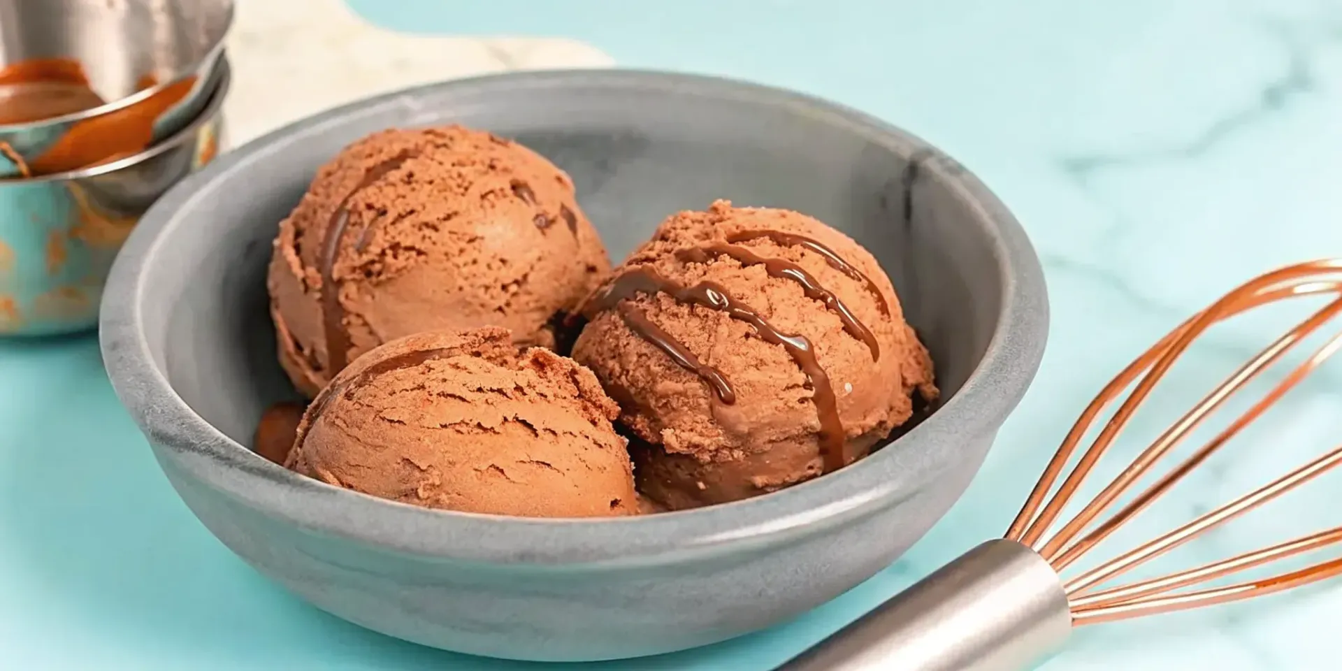 Rich, homemade chocolate whiskey ice cream with a chocolate drizzle.