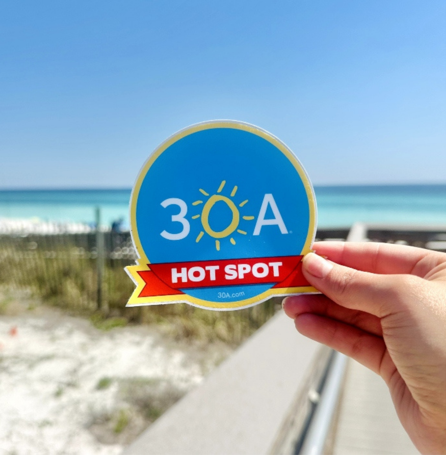 A person is holding a sticker that says 3 o a hot spot