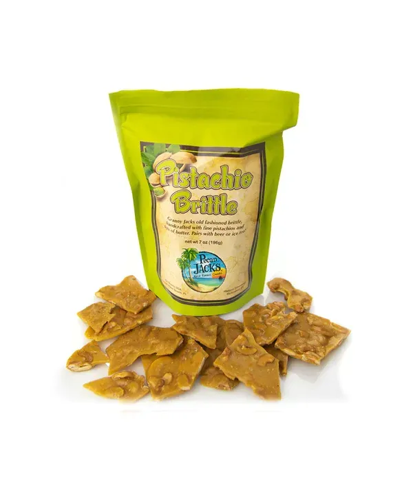 A bag of pistachio brittle is sitting next to a pile of brittle.