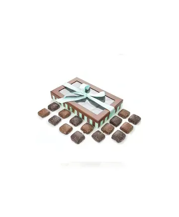 A box of chocolates is sitting on top of a table.