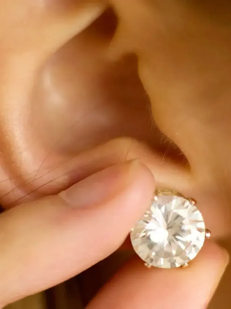 A close up of a person holding a device with the letter l on it