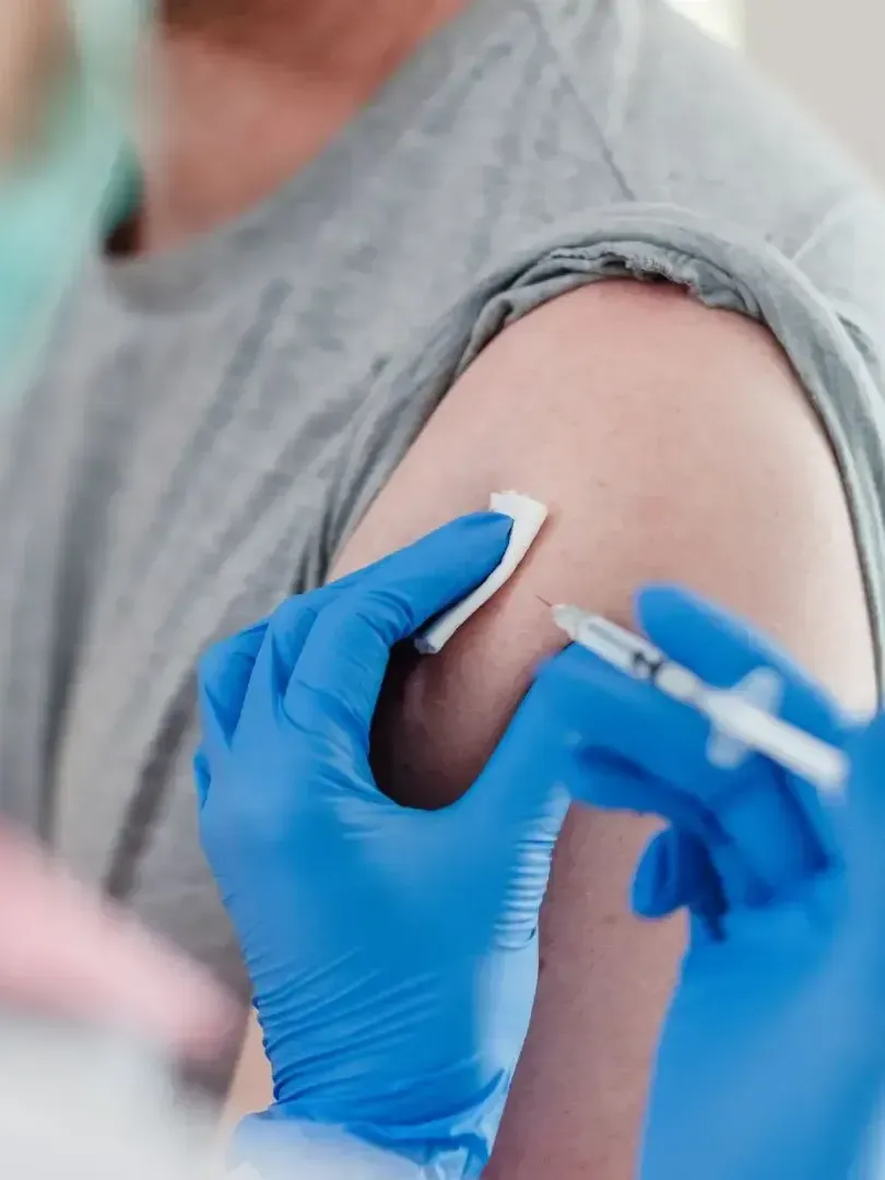 A person is getting a vaccine in their arm.