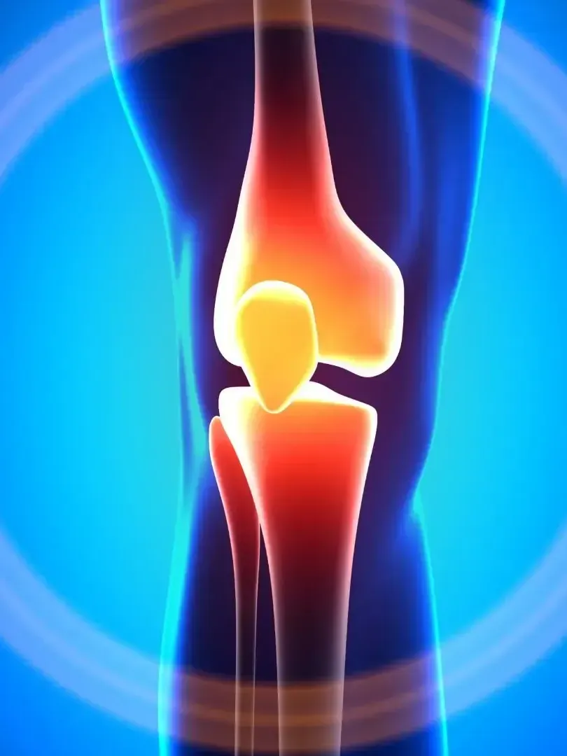 A close up of a person 's knee with a blue background.