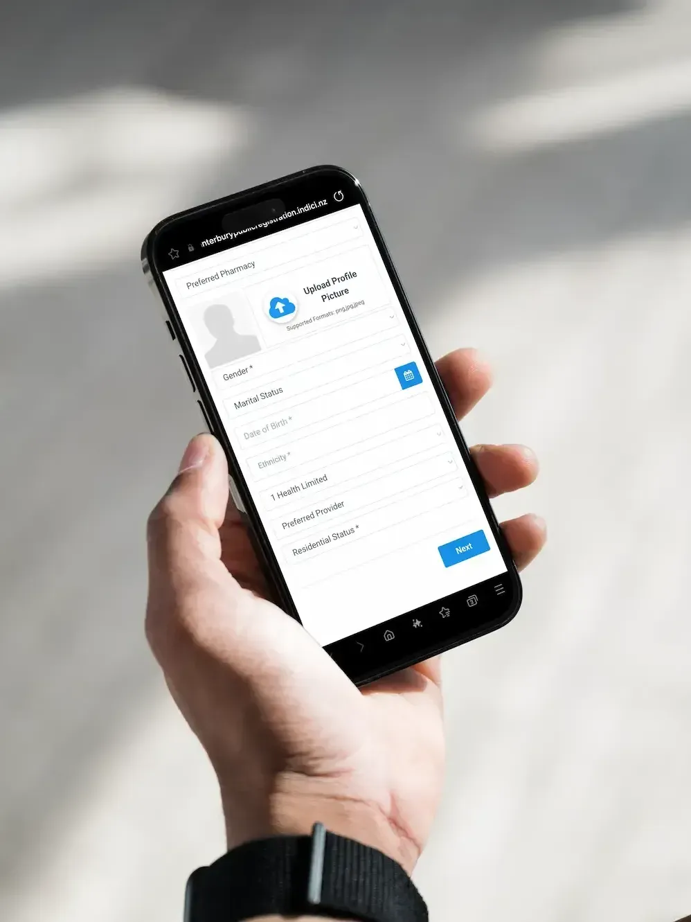 A person is holding a cell phone in their hand.