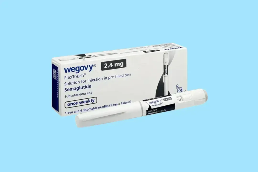 Wegovy 2.4 mg injection pen and box, white and blue, on a light blue background.