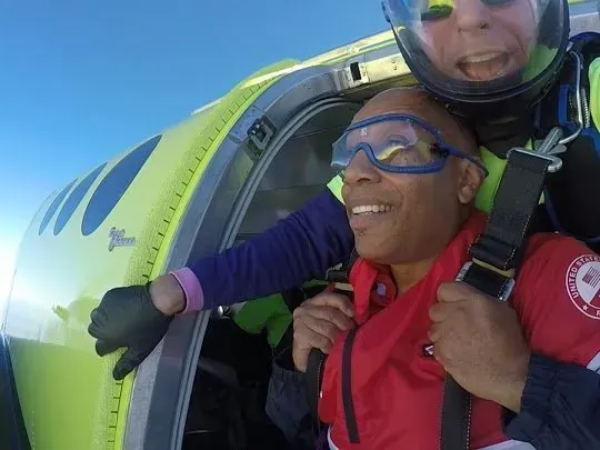 Instructor and student tandem skydiving over Kansas City