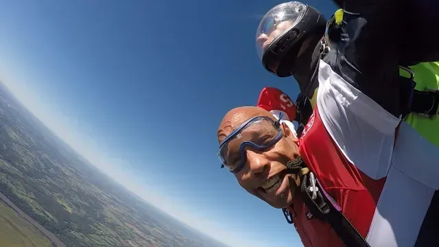 First-time tandem skydiver smiling during freefall near Kansas City