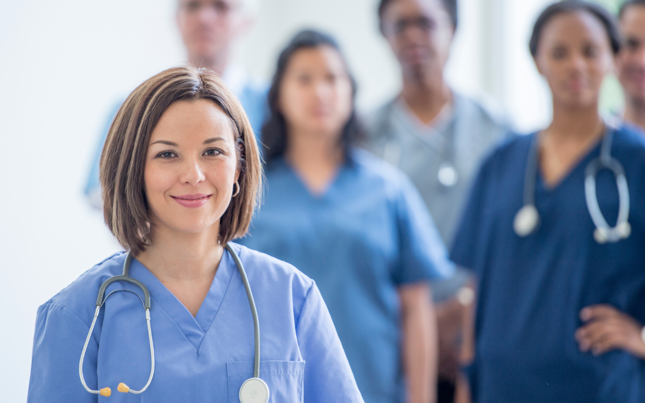 A group of doctors and nurses are standing in a line.