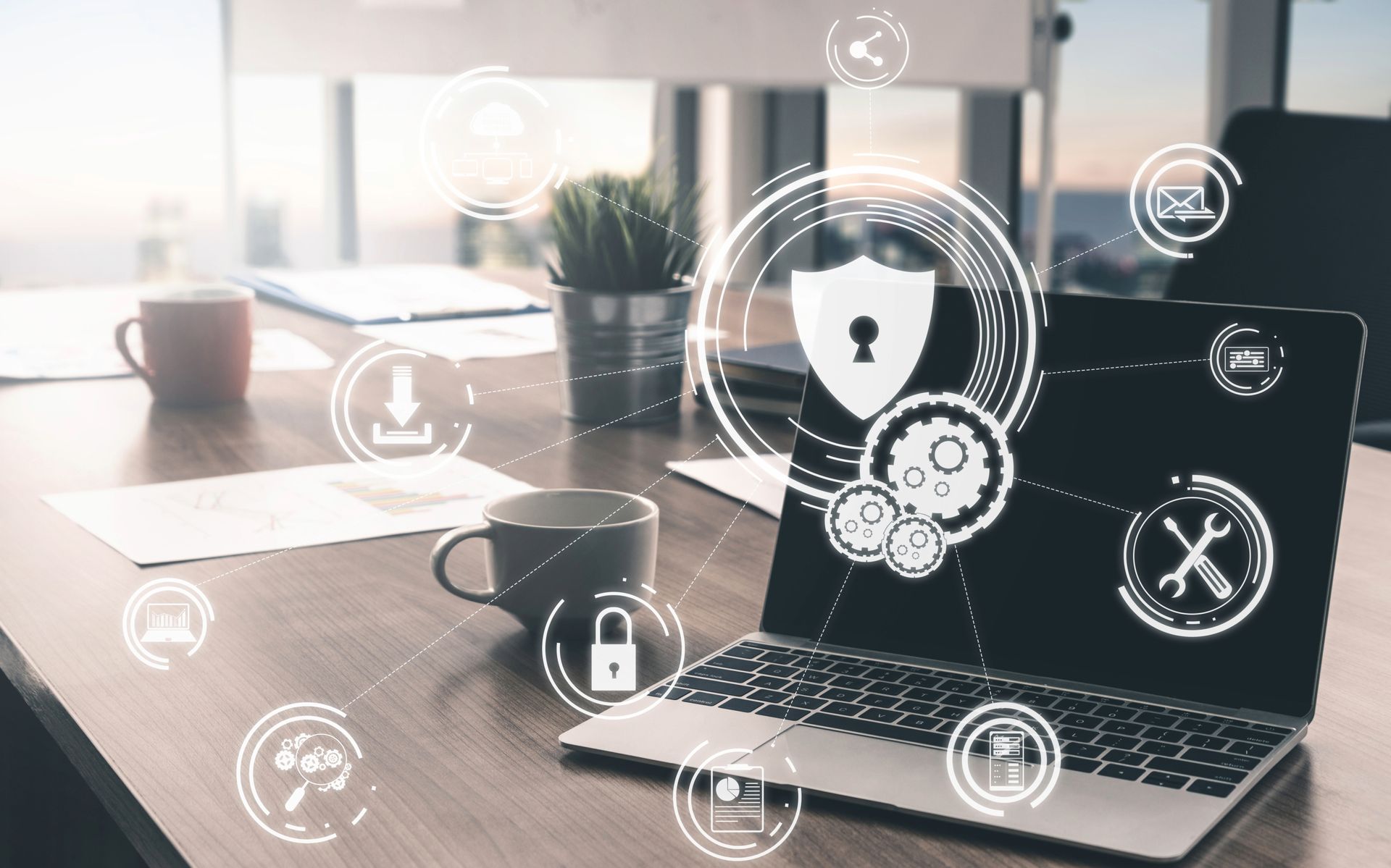 Laptop mit Cybersecurity-Symbolen auf einem Schreibtisch.
