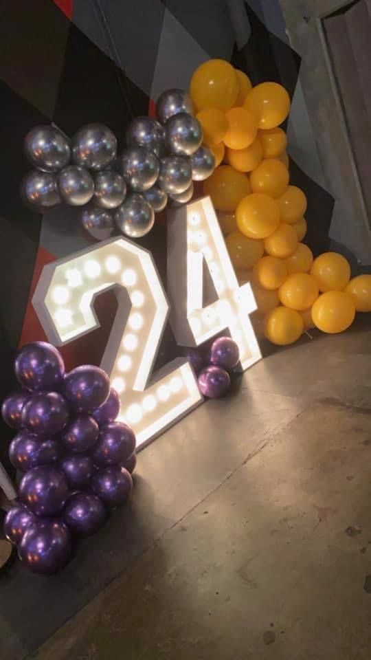Pink, black, and silver balloon archway