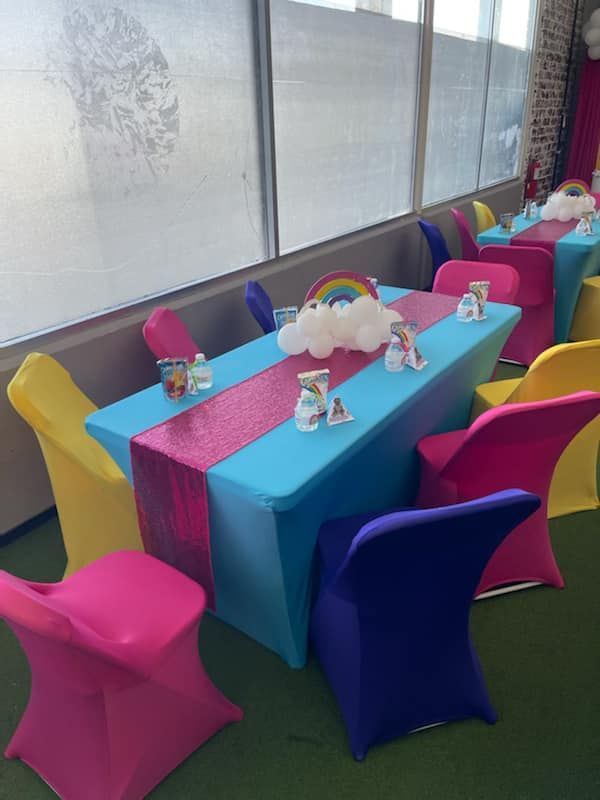 Colorful party tables with rainbow and cloud decor