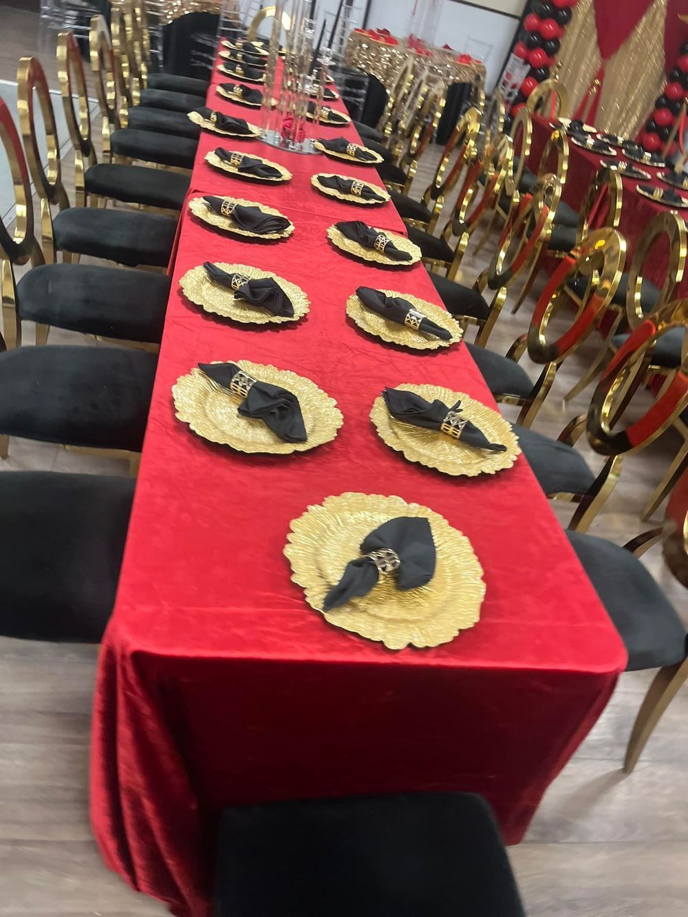 Long table set for an event with red tablecloth