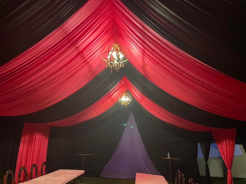 Red and black draped ceiling with chandeliers
