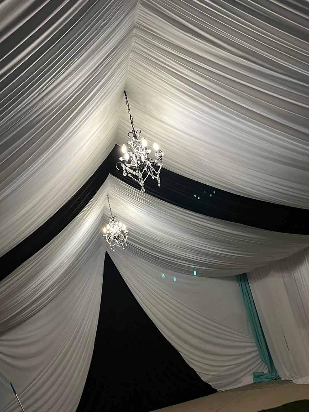 Elegant tent interior with white and black draped fabric