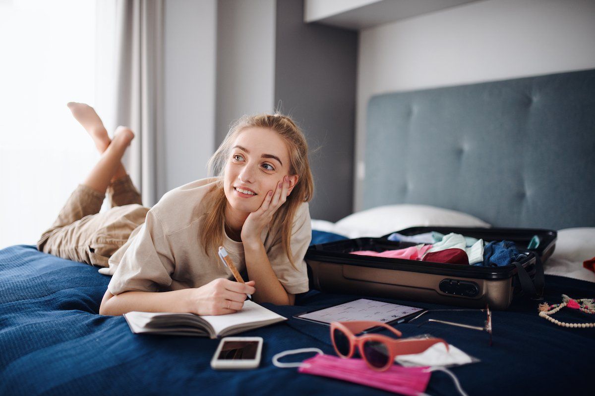 A girl planning in her apartment. Apply at The Lofts of Columbia in Missouri today!