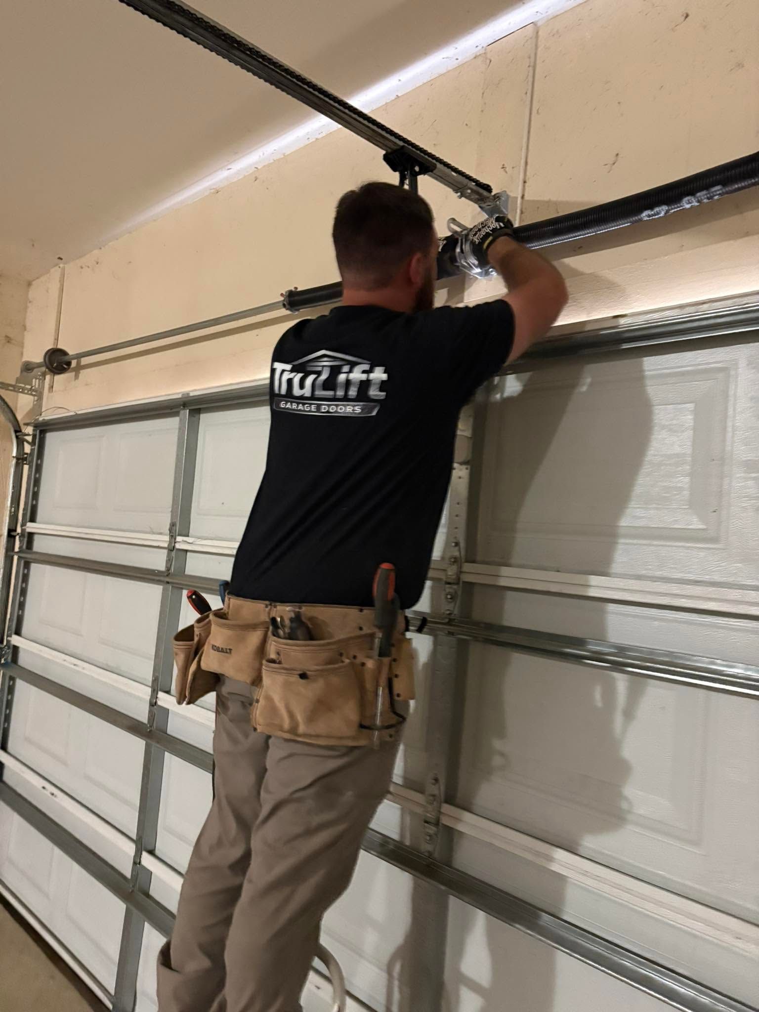 trulift garage doors technician servicing broken torsion spring