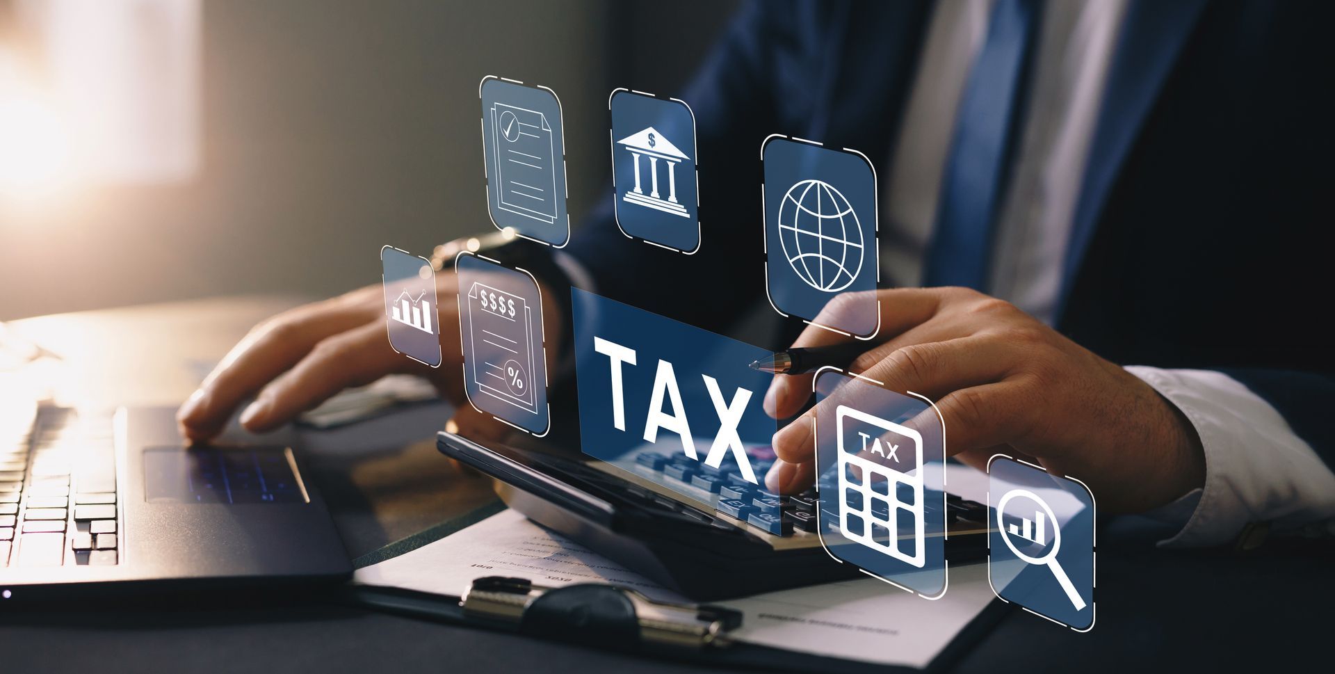 Hands typing on a laptop with digital tax icons hovering above the keyboard.