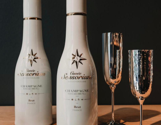 Two bottles of champagne and two champagne glasses on a table