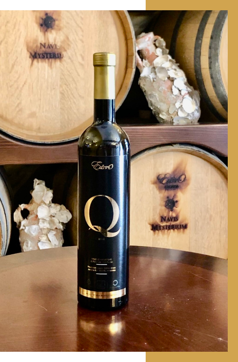 A bottle of wine with the letter q on it