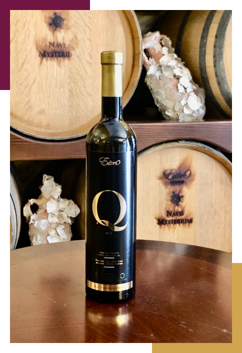 A bottle of wine with the letter q on it