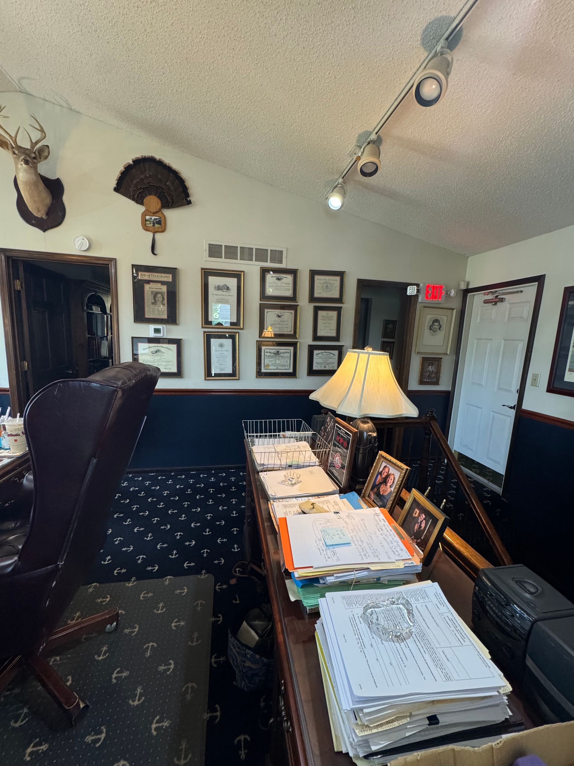 A man is sitting at a table with a model house and keys.