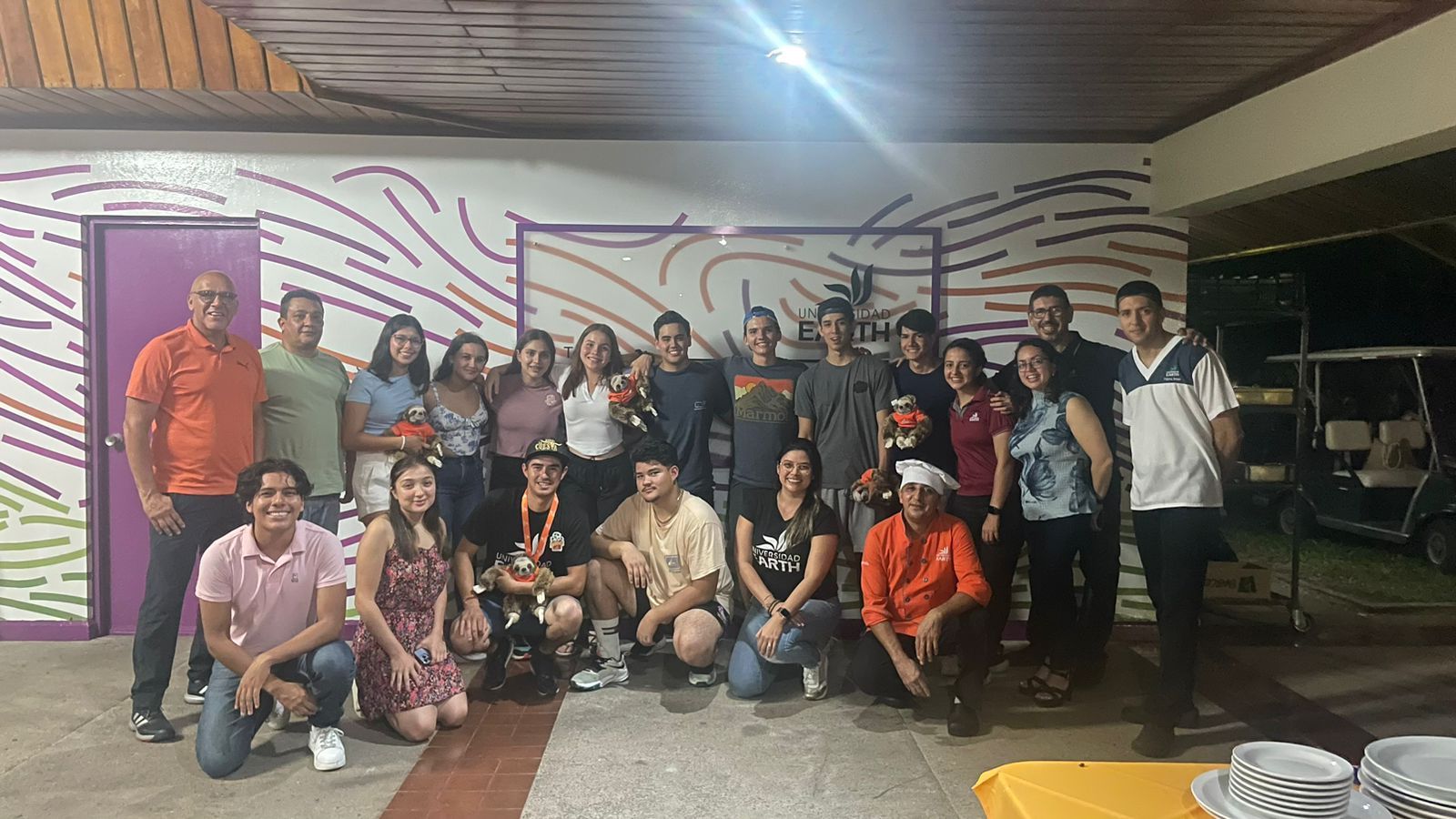A group of people are posing for a picture in a room.