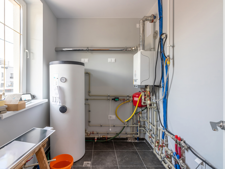 There is a water heater in the middle of the room.