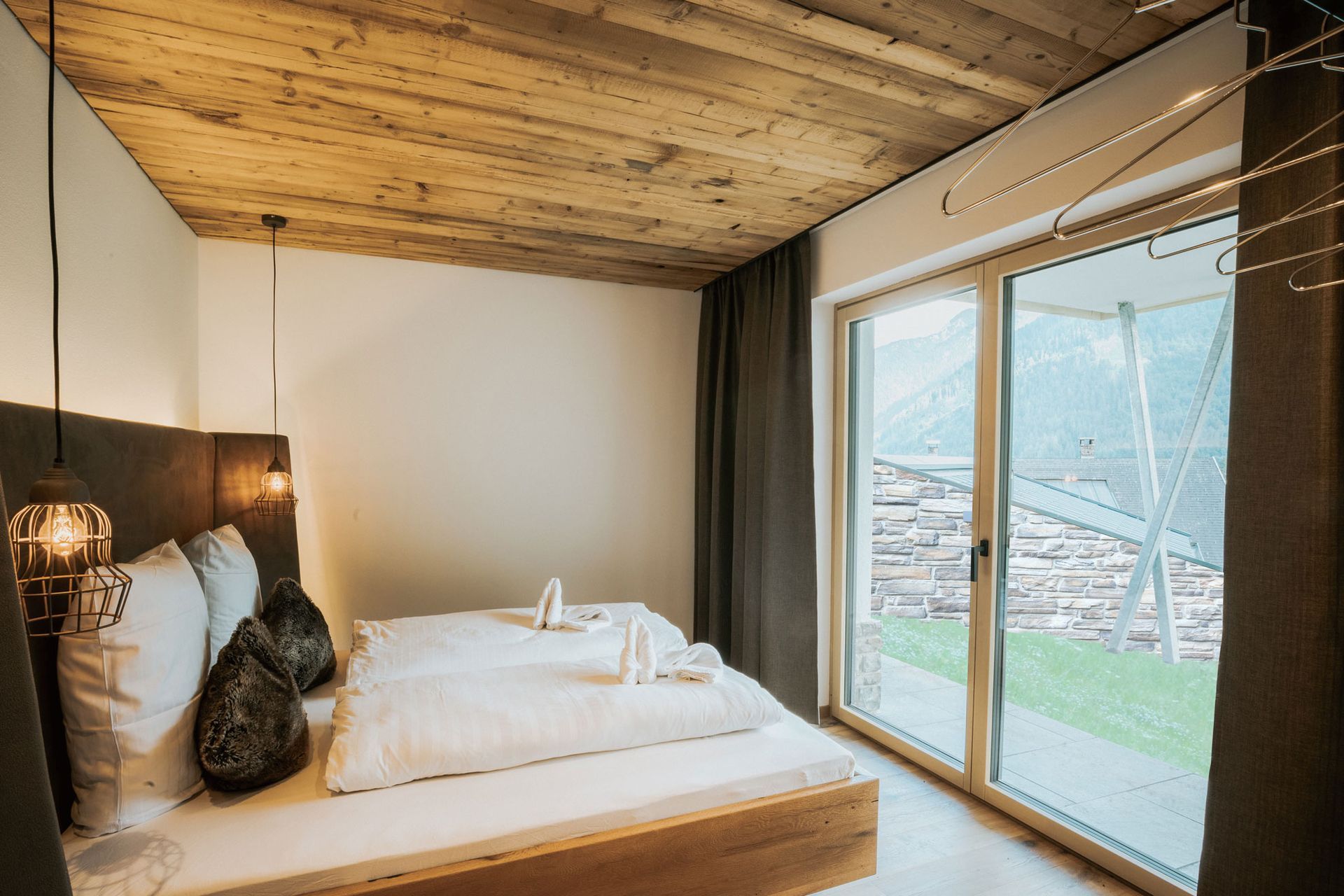 Ein Schlafzimmer mit großem Bett und Glasschiebetür.