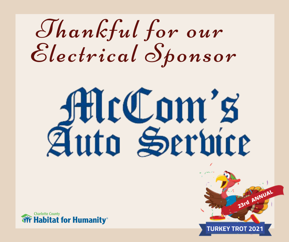 Sign thanking McCom's Auto Service for sponsoring a Habitat for Humanity Turkey Trot. A turkey mascot is also featured.