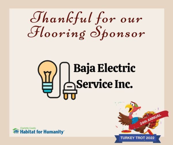 Sign thanking Baja Electric Service for sponsoring the Turkey Trot. Features lightbulb logo and turkey.