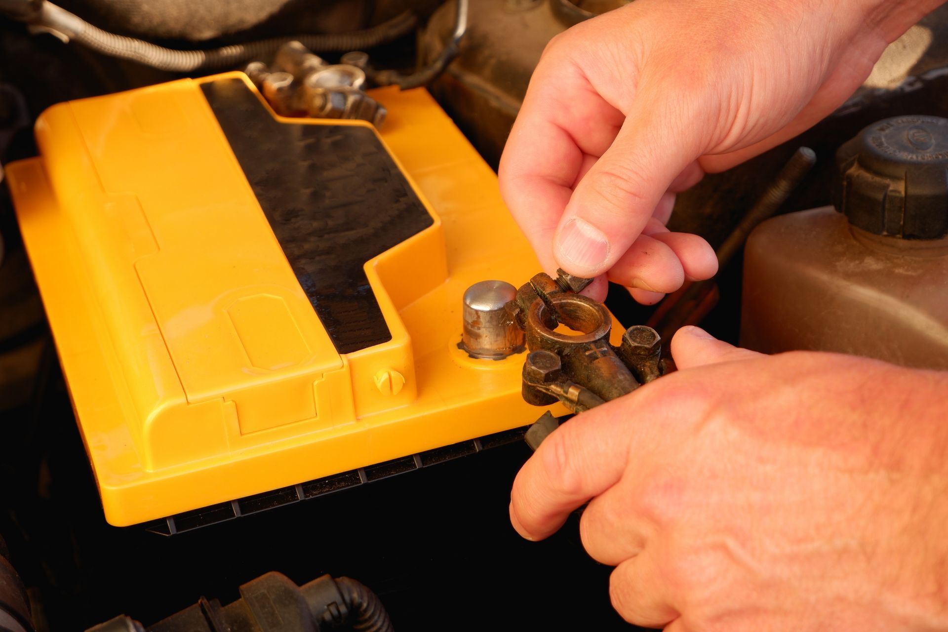 An auto mechanic changes the battery in a car | car battery store | Ontario, CA