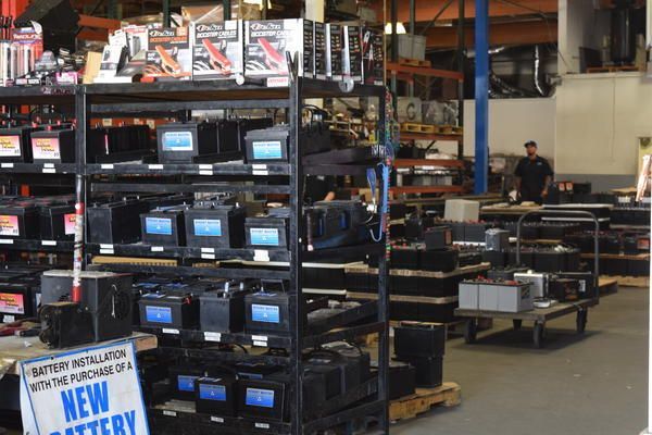 A warehouse filled with lots of batteries and a sign that says new battery