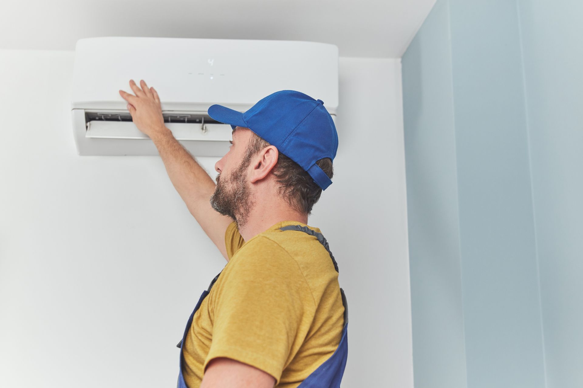 J&K technician maintaining air conditioning unit.