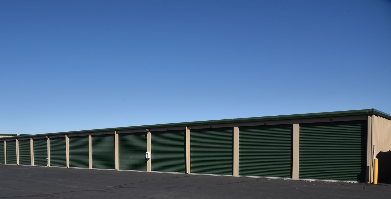 A row of green garage doors with numbers on them