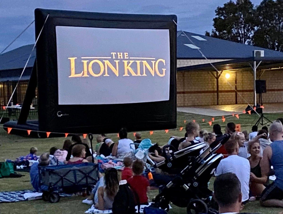 group of people gathered for outdoor movie