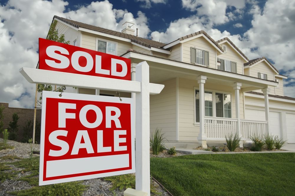 A House With a for Sale Sign in Front of It — Richardson Conveyancing in Hunter Valley, NSW