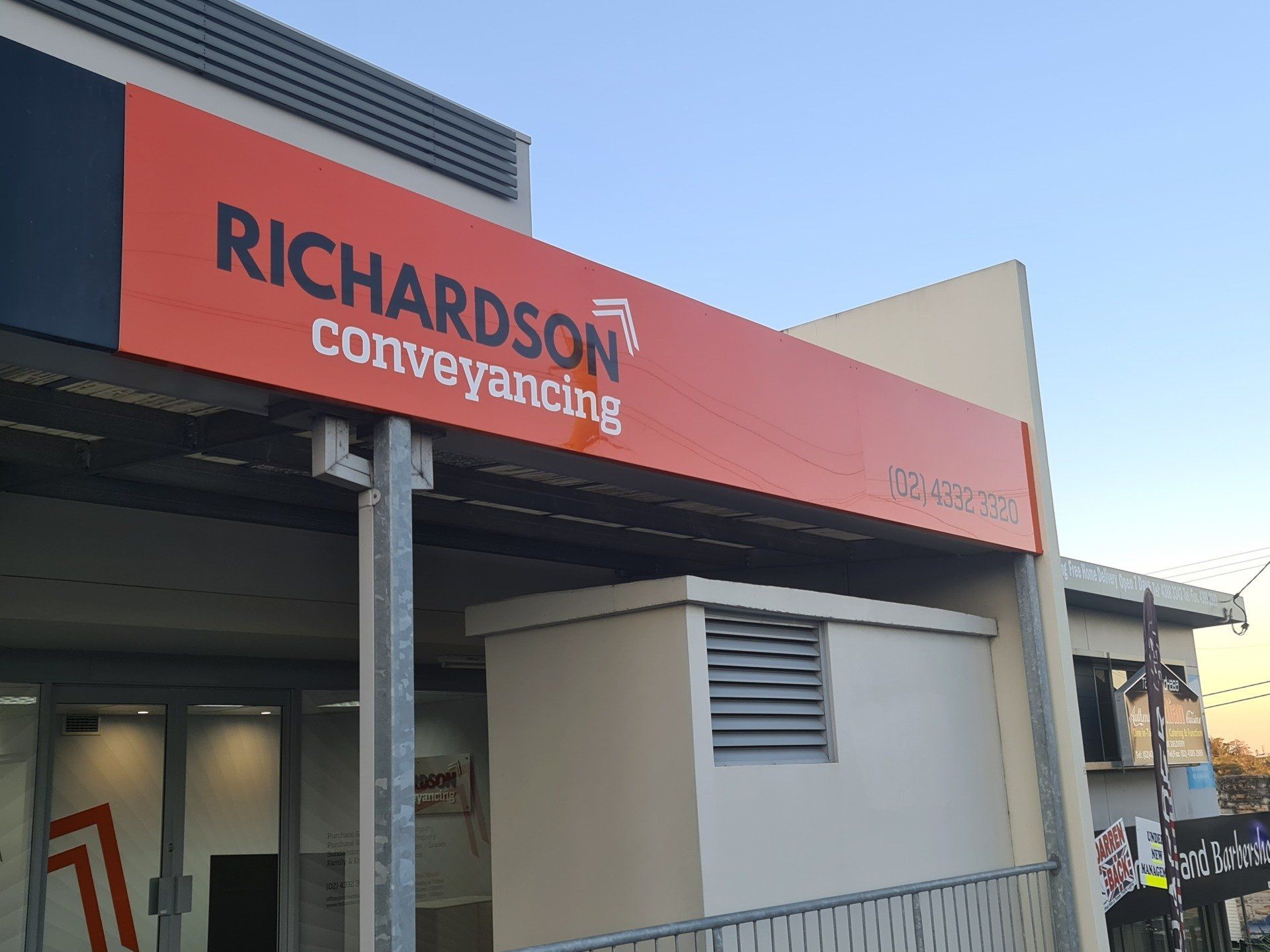 A Building With a Sign That Says Richardson Conveyancing on It — Richardson Conveyancing in Tumbi Umbi, NSW