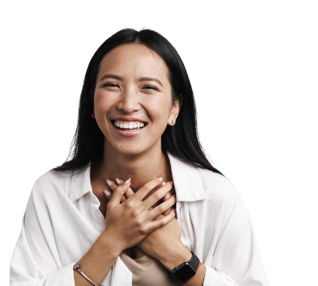 A woman in a white shirt is smiling with her hands on her chest.