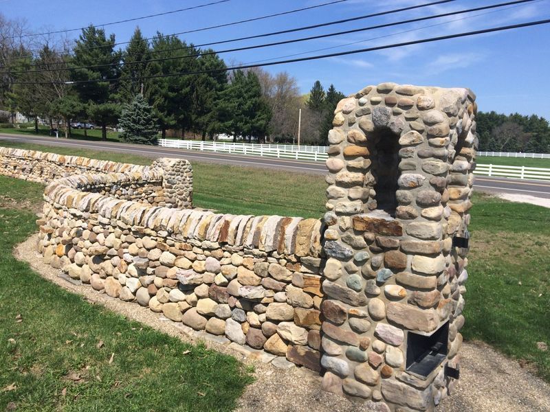 A stone wall with a hole in the middle of it
