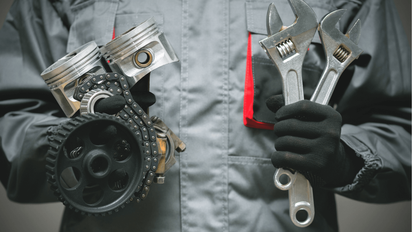 A mobile mechanic holding wrenches