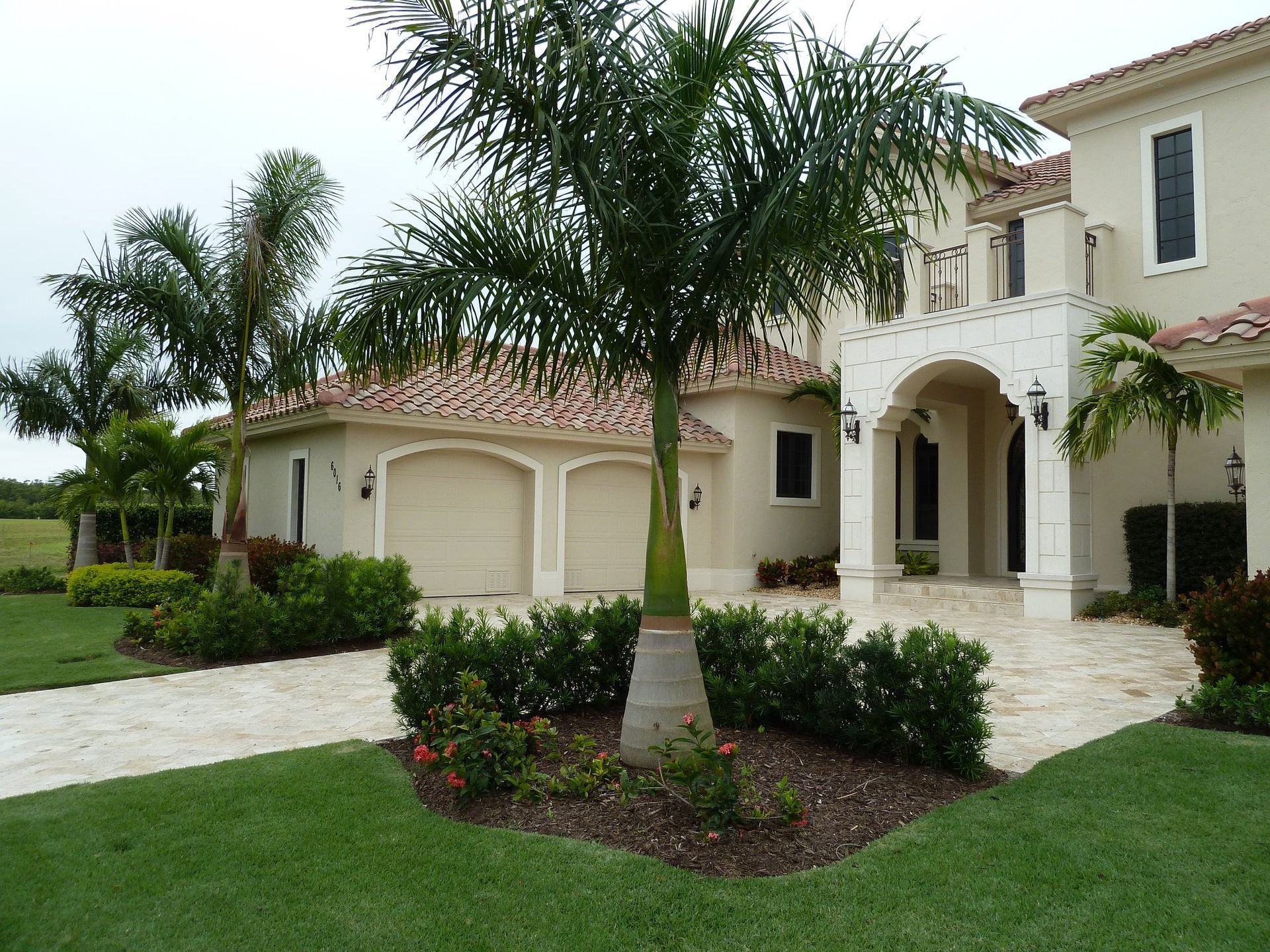 A large house with a palm tree in front of it