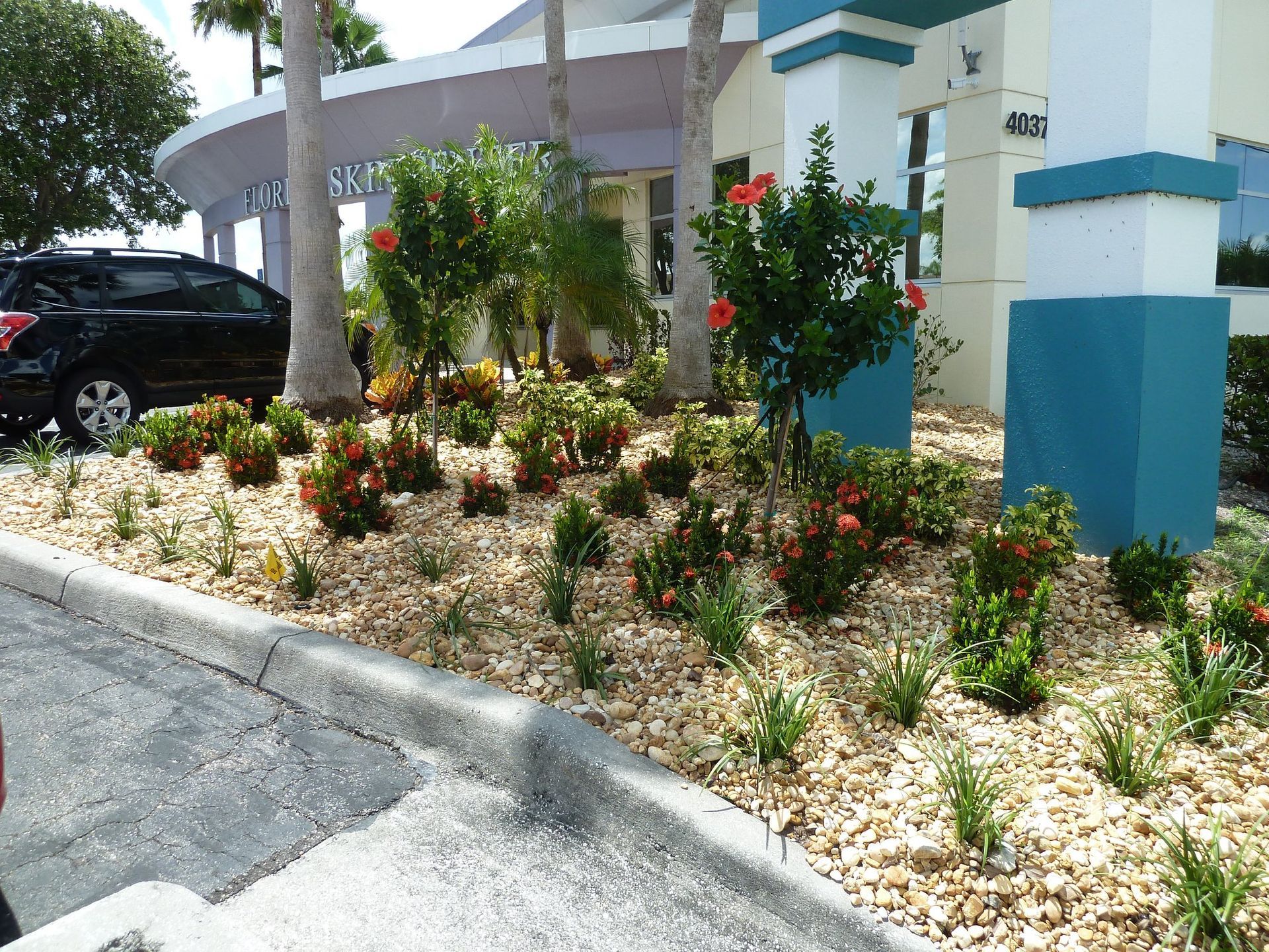A black car is parked in front of a building
