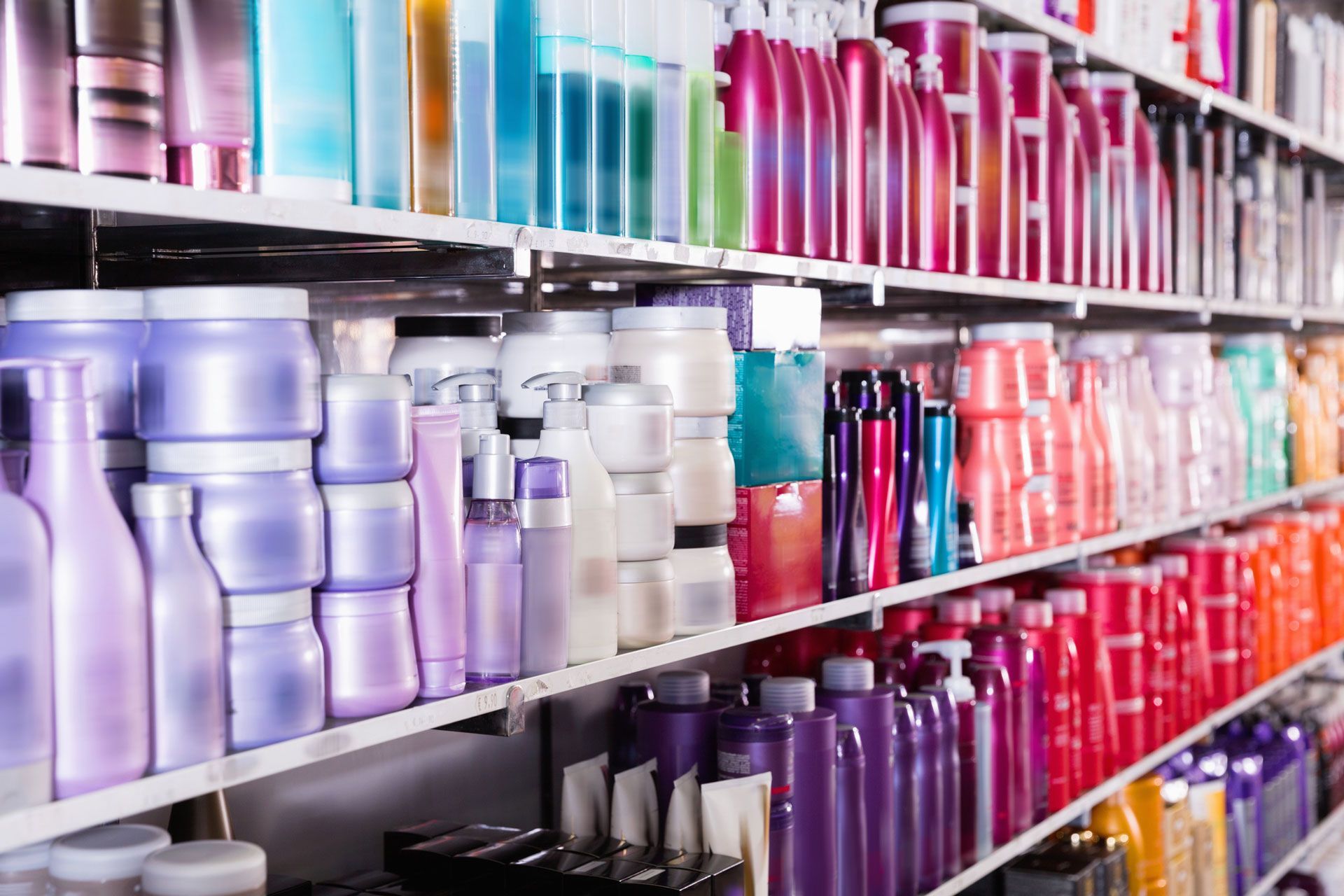 A shelf filled with lots of different types of hair products in a store.