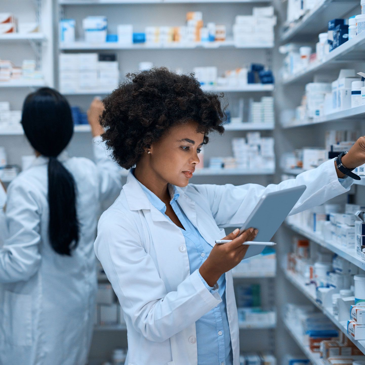 A woman is using a tablet in a pharmacy.