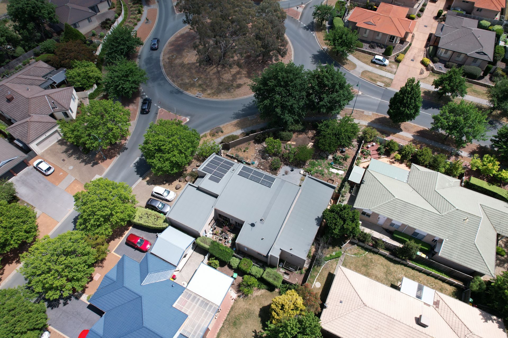 An aerial view of a residential area with houses and trees