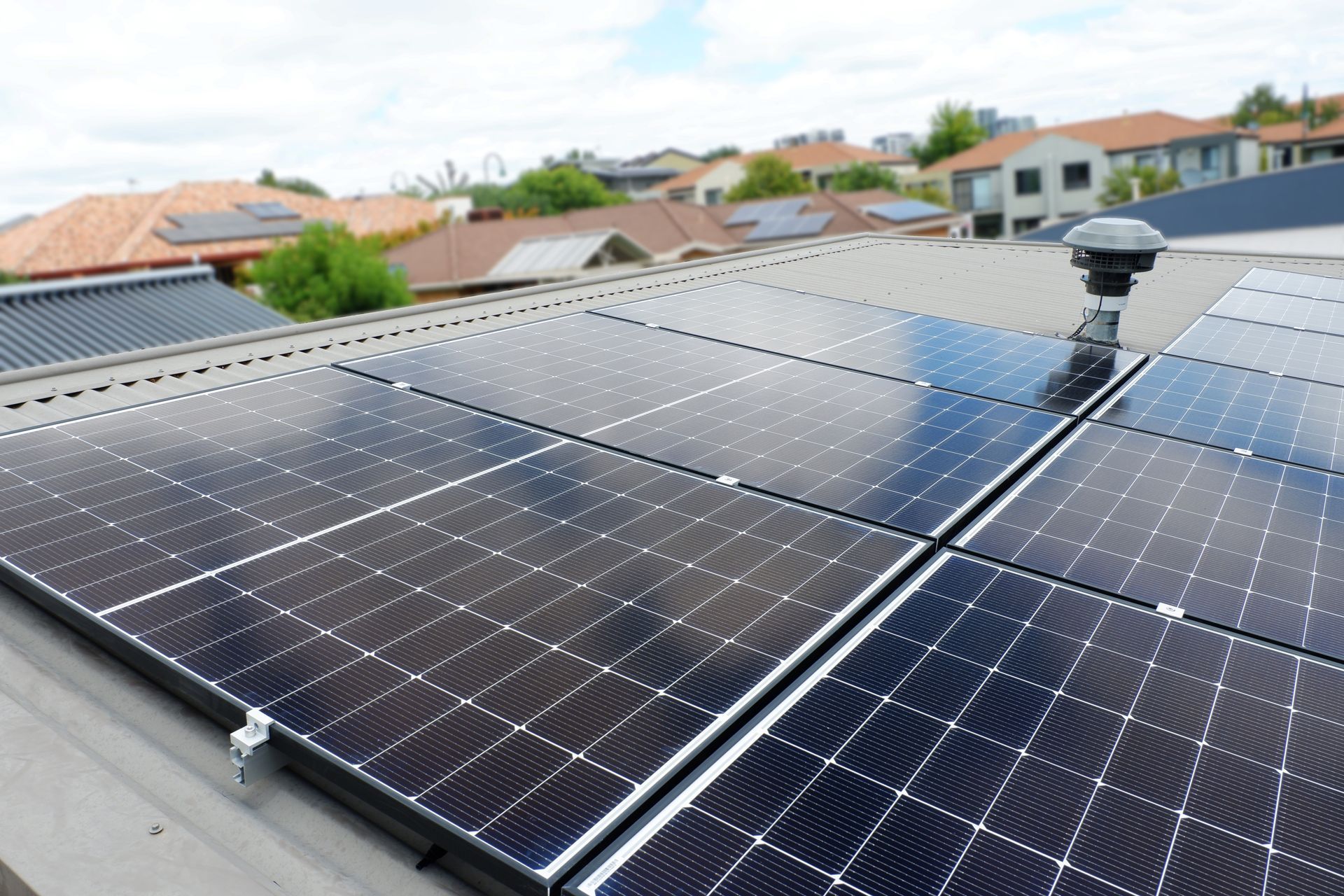 A row of solar panels on the roof of a house